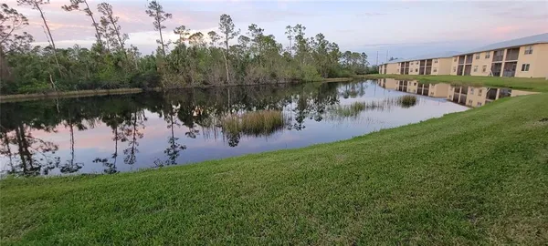 a view of a lake with houses in the back