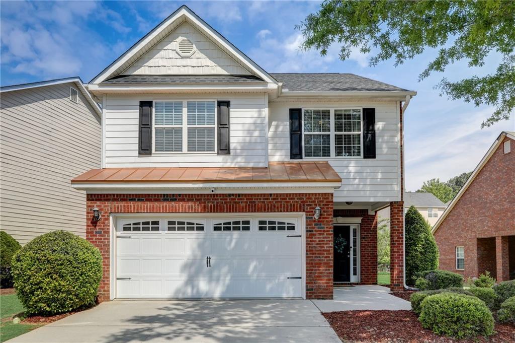320 Clover Brook Drive Locust Grove, GA 30248 - Photo 1 of 1 a front view of a house with a garden