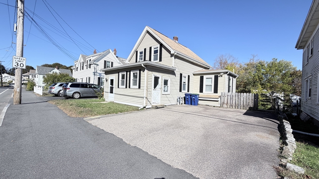 a front view of a house with a garden and patio