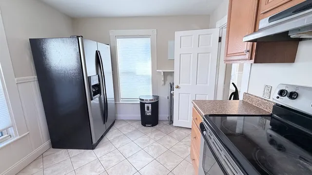 a kitchen with stainless steel appliances granite countertop a refrigerator and a stove