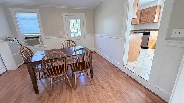 a view of a dining room with furniture and wooden floor