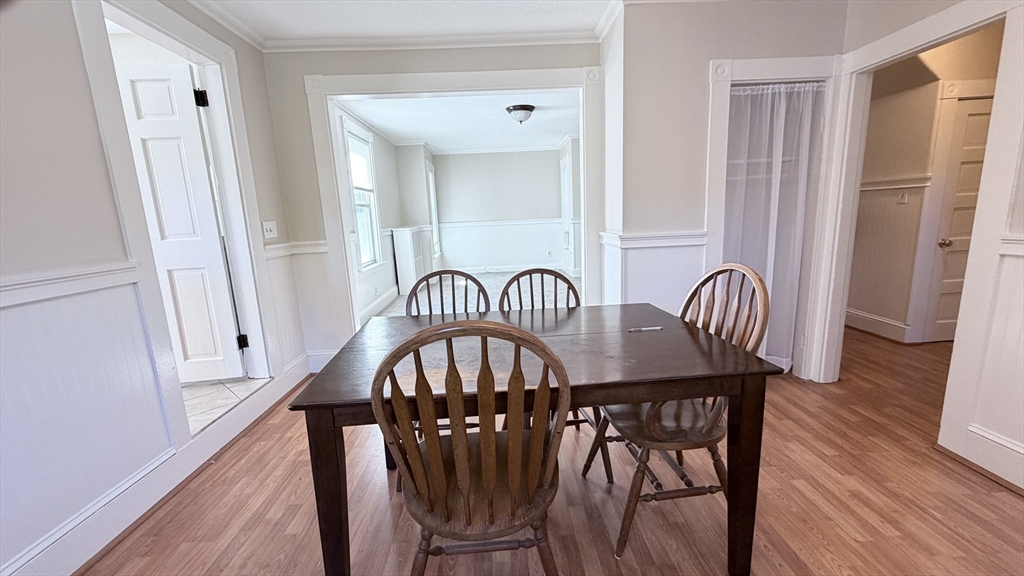 391 Commercial Street Braintree, MA 02184 - Photo 8 of 21 a view of a dining room with furniture and wooden floor