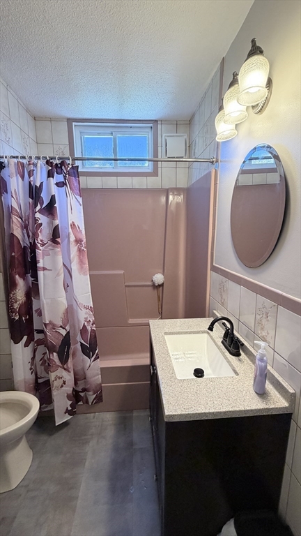 391 Commercial Street Braintree, MA 02184 - Photo 9 of 21 a bathroom with a sink a toilet and shower