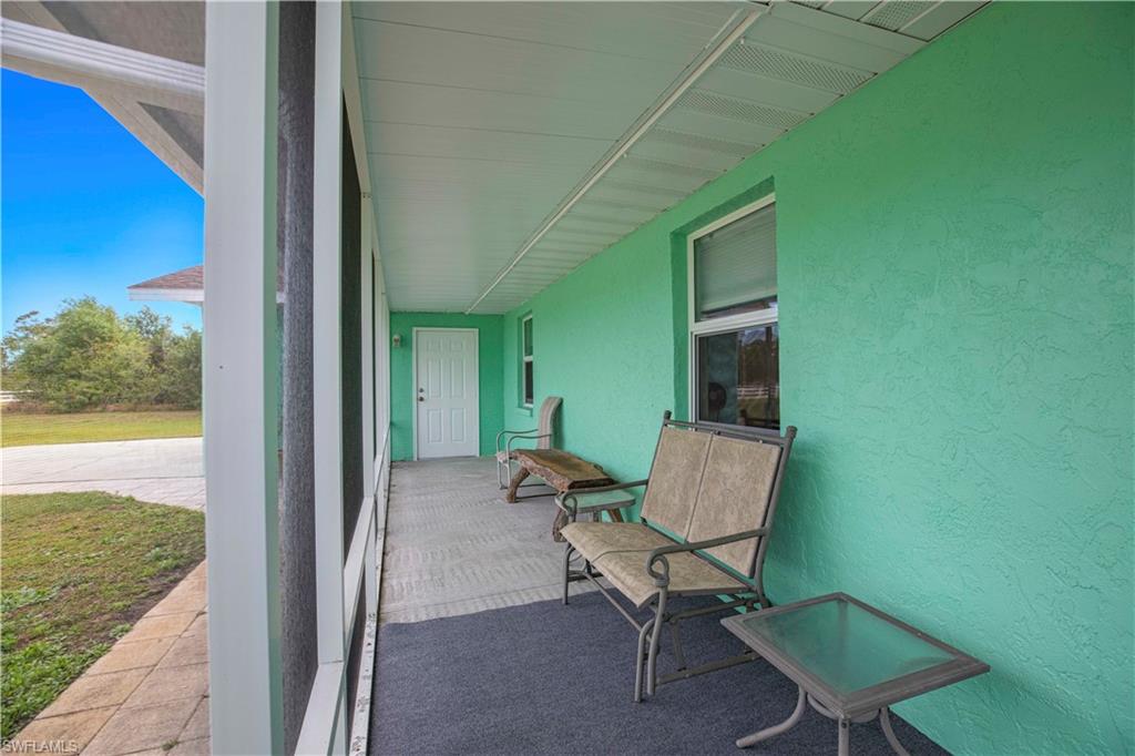 1900 Platt Road Naples, FL 34120 - Photo 6 of 35 Screened Front Porch with Covered Walk to 2 Car Garage