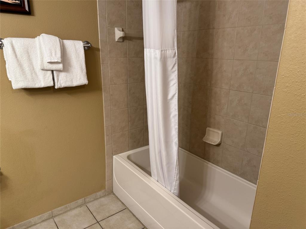 8762 Worldquest Boulevard, Unit 6203 Orlando, FL 32821 - Photo 15 of 31 a bathroom with a bathtub