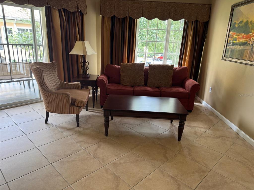 8762 Worldquest Boulevard, Unit 6203 Orlando, FL 32821 - Photo 20 of 31 a living room with furniture and a window