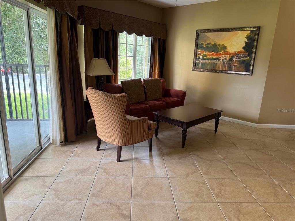 8762 Worldquest Boulevard, Unit 6203 Orlando, FL 32821 - Photo 24 of 31 a living room with furniture and a large window