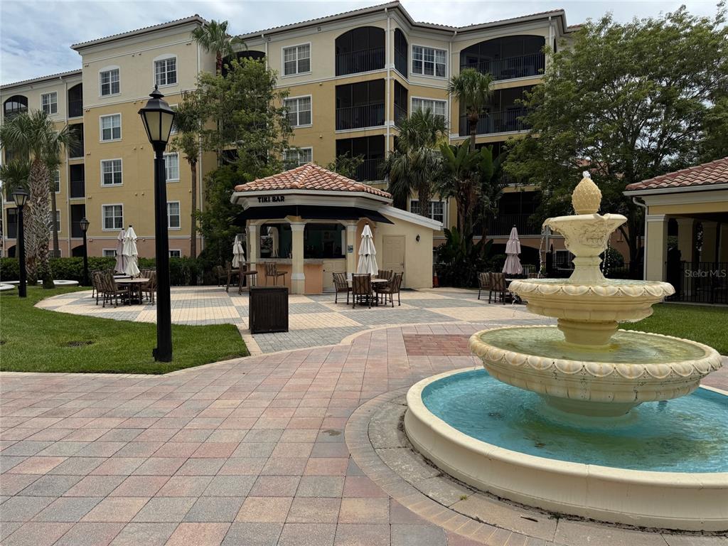 8762 Worldquest Boulevard, Unit 6203 Orlando, FL 32821 - Photo 25 of 31 a front view of a house with garden and trees