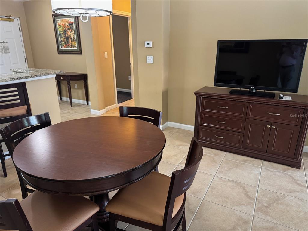 8762 Worldquest Boulevard, Unit 6203 Orlando, FL 32821 - Photo 7 of 31 a room with furniture and flat screen tv