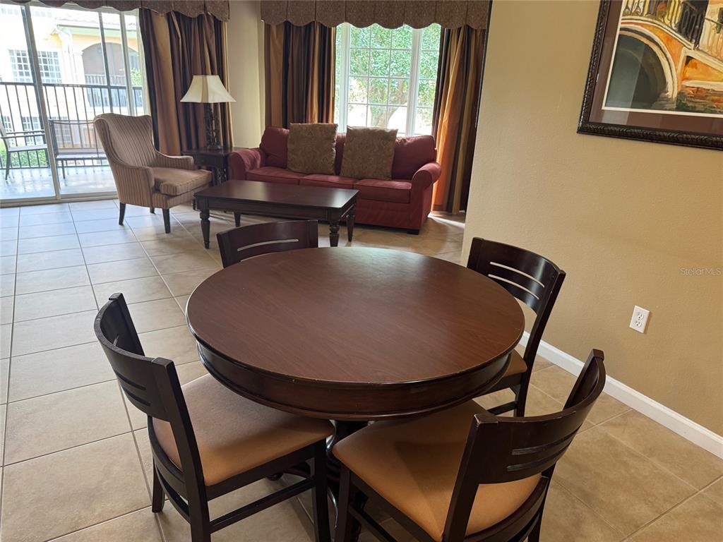 8762 Worldquest Boulevard, Unit 6203 Orlando, FL 32821 - Photo 8 of 31 a view of a dining room with furniture and window