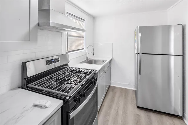 a kitchen with a stove and a refrigerator