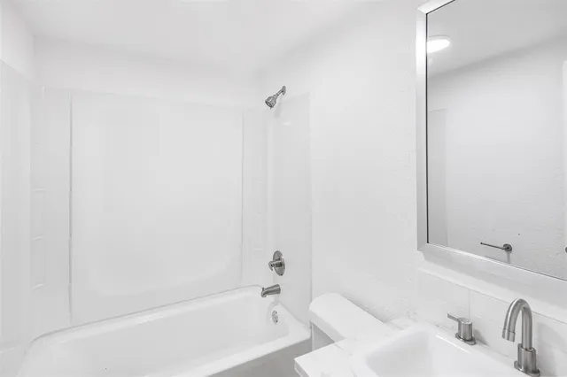 a bathroom with a bathtub and shower