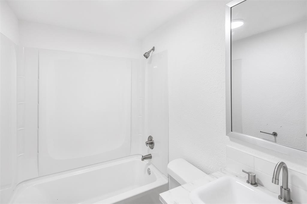 1911 Benson Street, Unit 2 Houston, TX 77020 - Photo 9 of 12 a bathroom with a bathtub and shower