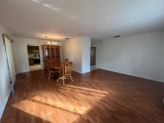 a room with furniture and view of kitchen