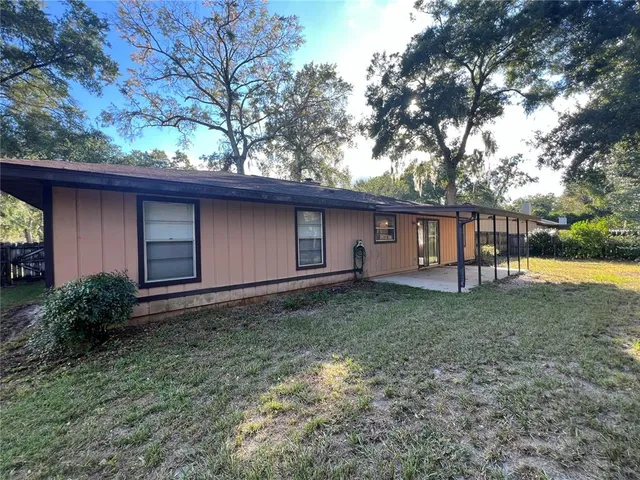 a view of a backyard with a garden and trees