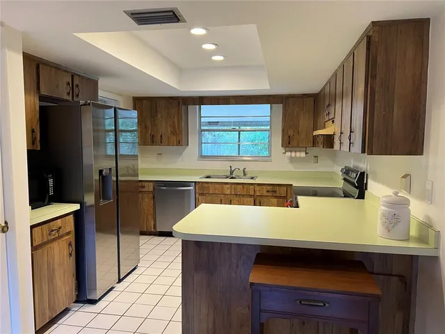 a kitchen with a sink appliances and cabinets