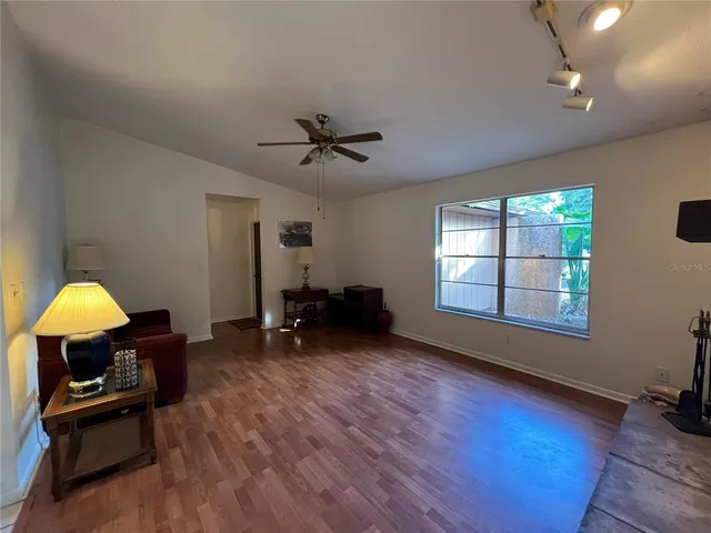 a view of a livingroom with furniture and a window