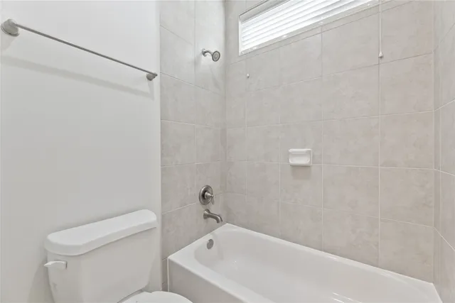 a bathroom with a bathtub and toilet