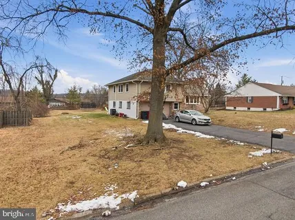 a view of a house with a yard covered in snow