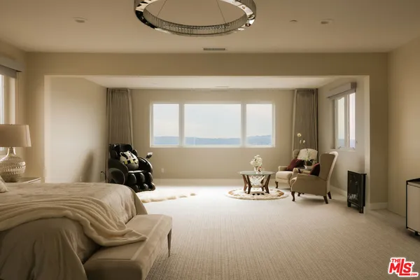 a bedroom with furniture and a large window