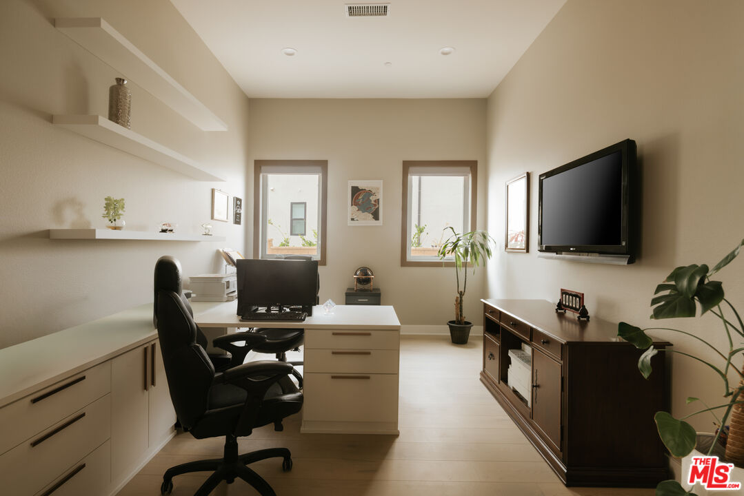 11773 Greenwood Drive Porter Ranch, CA 91326 - Photo 14 of 20 a view of a workspace with furniture and a flat screen tv