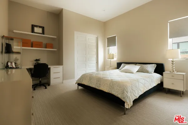 a bedroom with a bed chair and a window