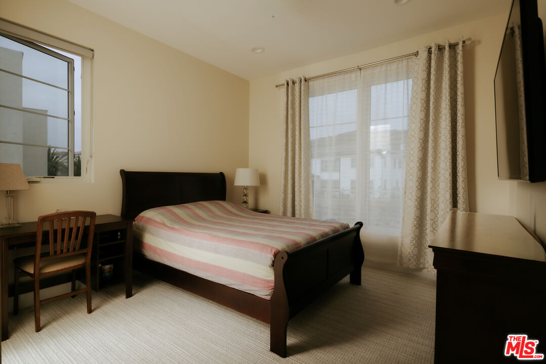 11773 Greenwood Drive Porter Ranch, CA 91326 - Photo 19 of 20 a bedroom with a bed and a window