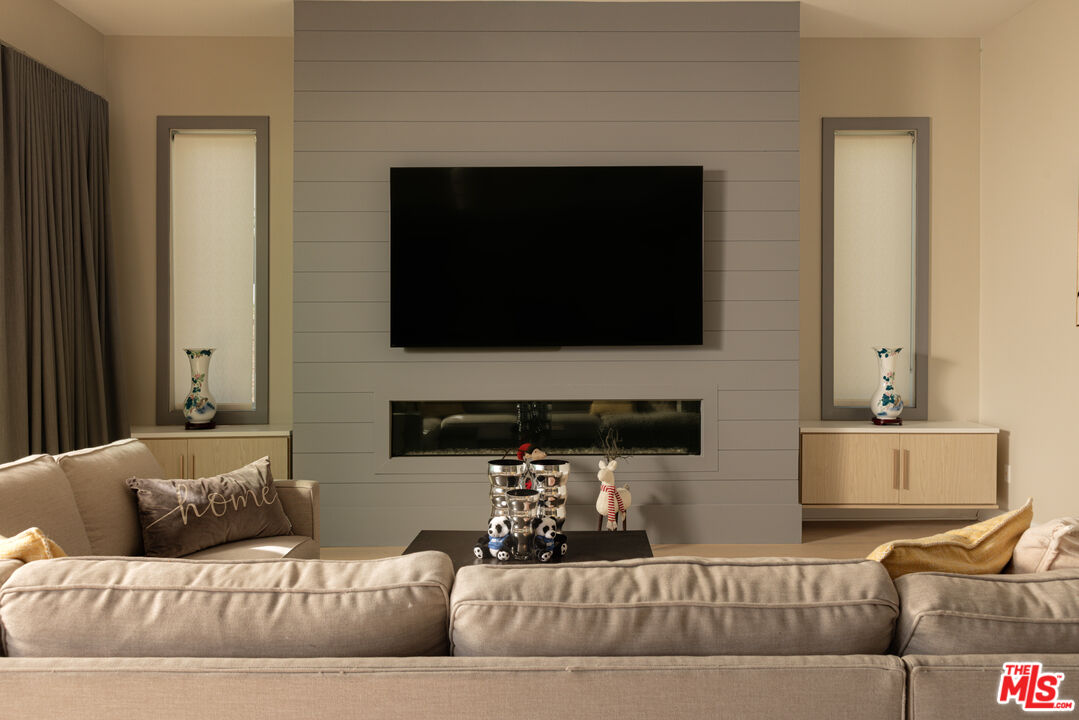 11773 Greenwood Drive Porter Ranch, CA 91326 - Photo 4 of 20 a living room with furniture and a flat screen tv