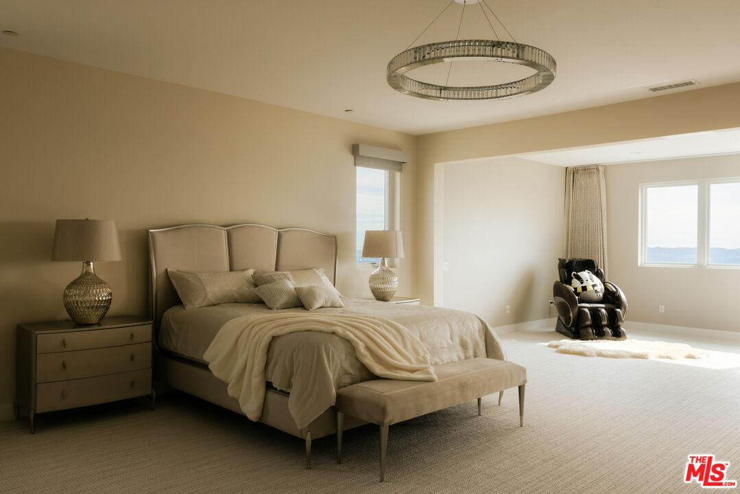 11773 Greenwood Drive Porter Ranch, CA 91326 - Photo 10 of 20 a bedroom with a bed and a chandelier