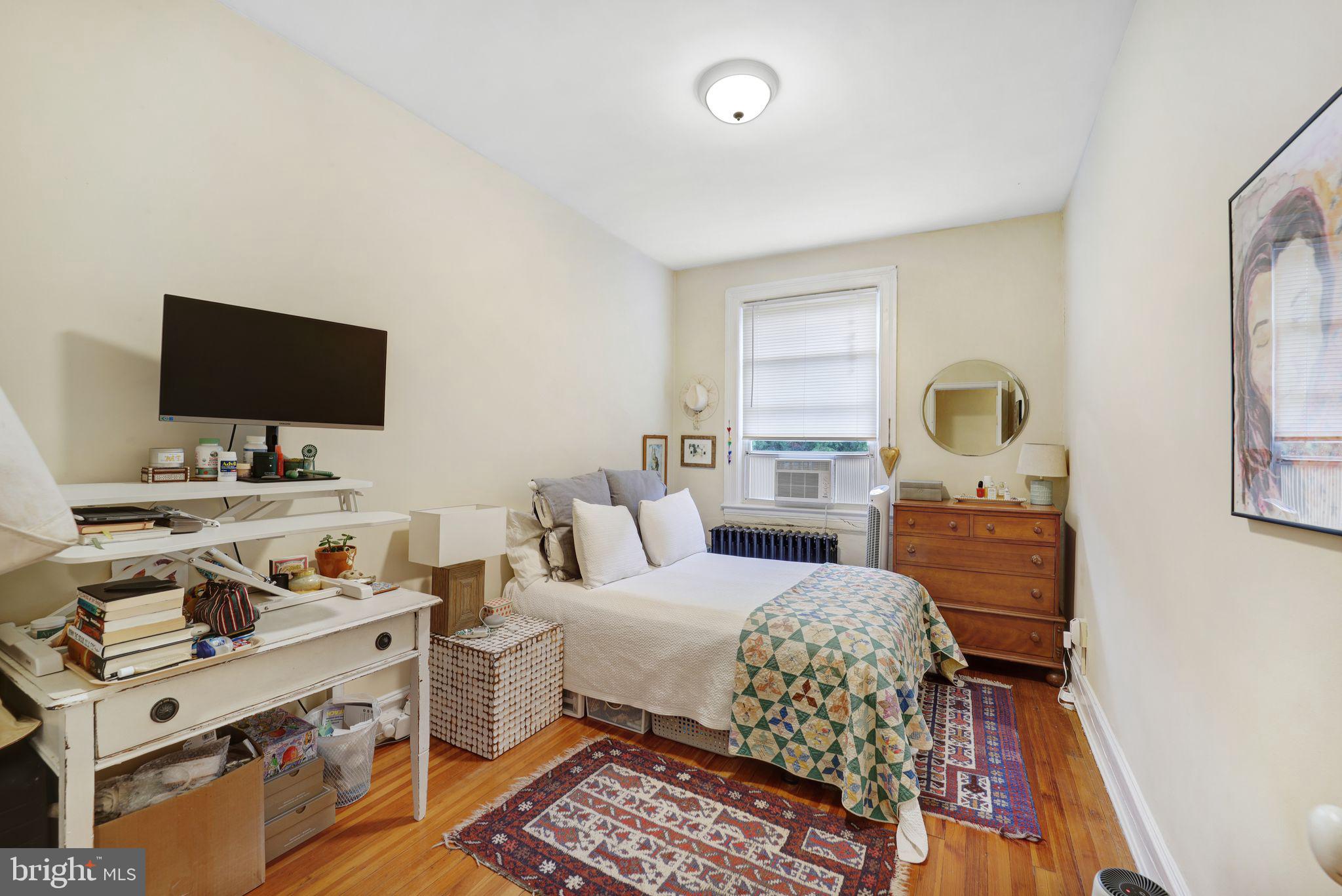 1426 12th Street Northwest, Unit 5 Washington, DC 20005 - Photo 17 of 21 a bedroom with a bed and flat screen tv
