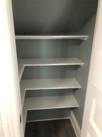 a view of walk in closet with empty racks