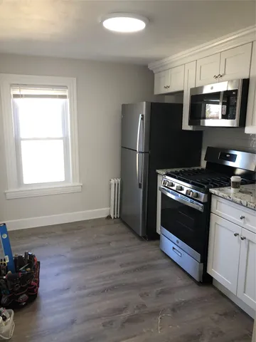 a kitchen with a refrigerator stove and microwave