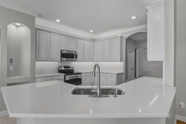 a kitchen with a sink stainless steel appliances and cabinets