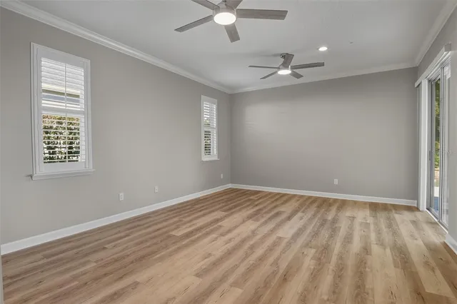 wooden floor in an empty room with a window
