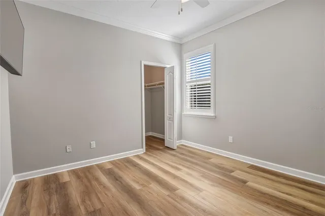 a view of an empty room with wooden floor