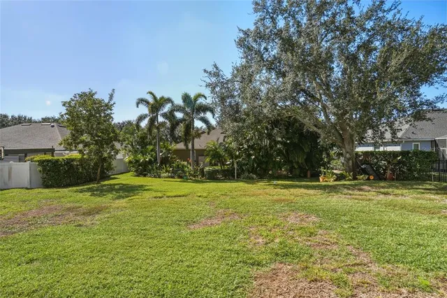 an aerial view of residential houses with yard