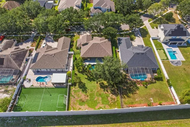 an aerial view of residential houses with swimming pool