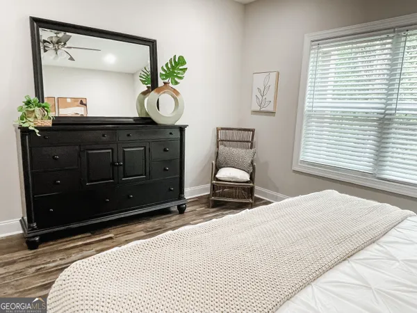 a bedroom with a bed and a dresser