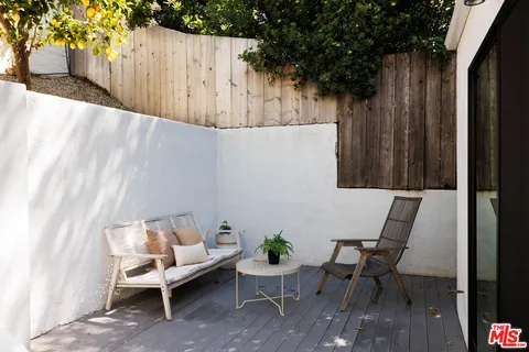 a balcony with table and chairs
