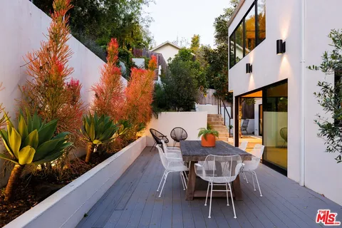 a wooden bench sitting in front of a house