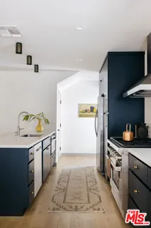 a kitchen with stainless steel appliances granite countertop a sink and a stove top oven