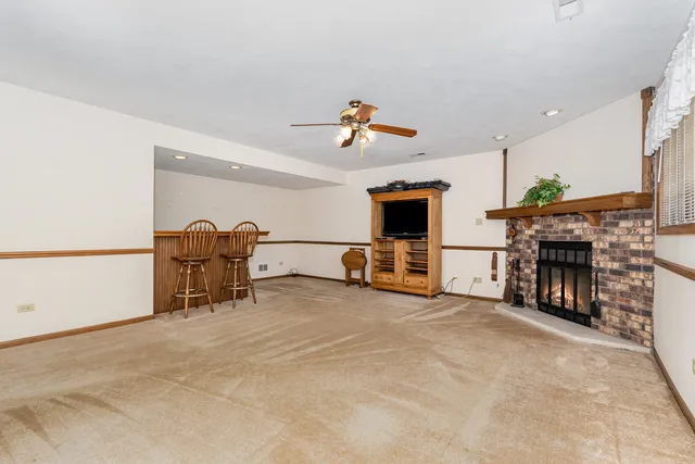 a view of a livingroom with furniture and a fireplace