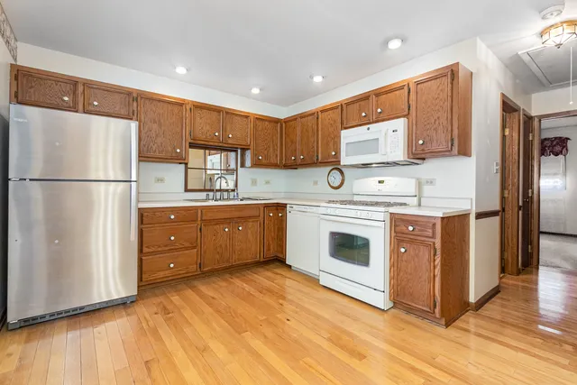 a kitchen with stainless steel appliances a refrigerator sink and cabinets