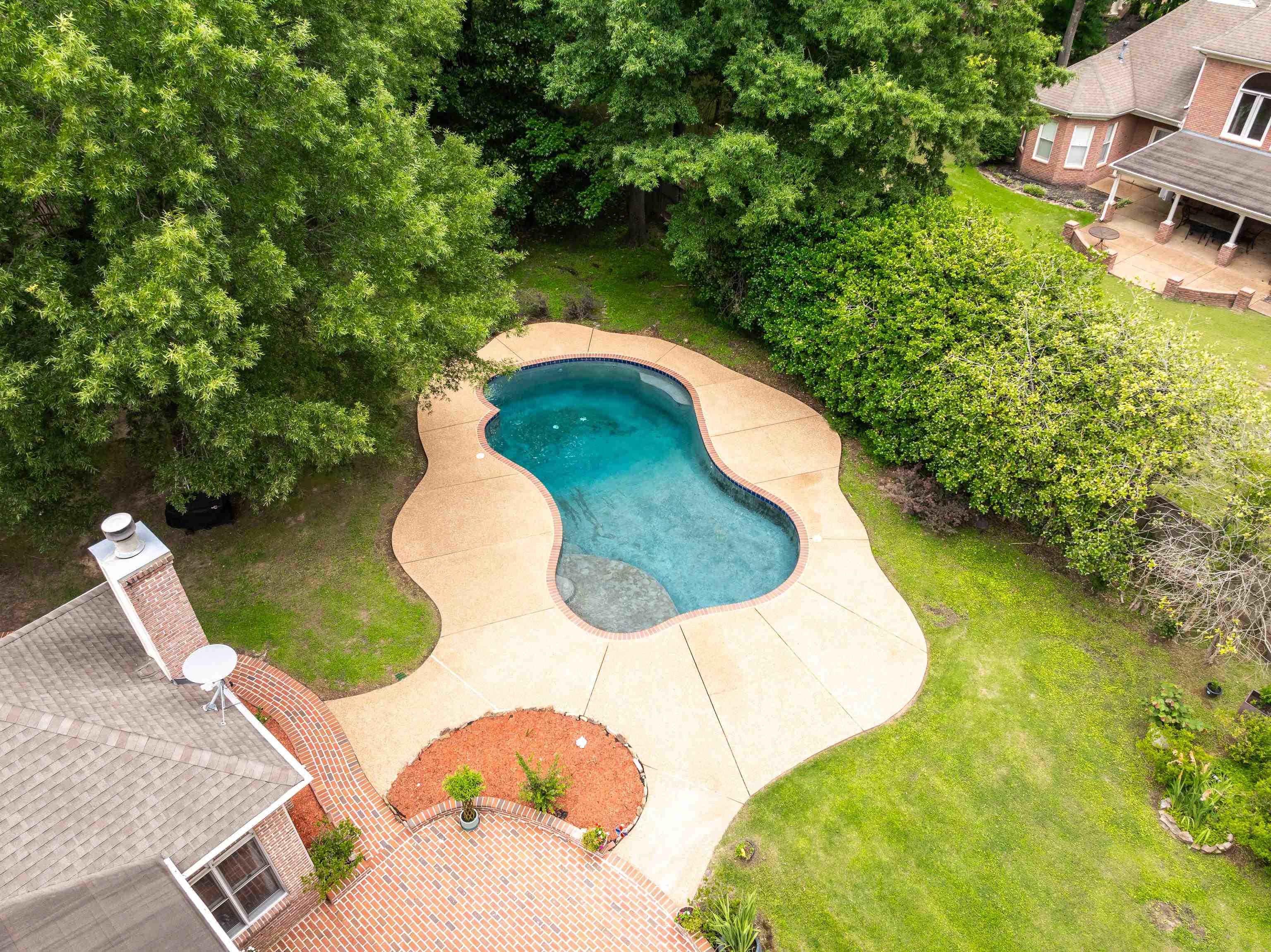 350 Bluff Ridge Cove Memphis, TN 38018 - Photo 36 of 37 Freeform swimming pool with expansive surrounding concrete decking