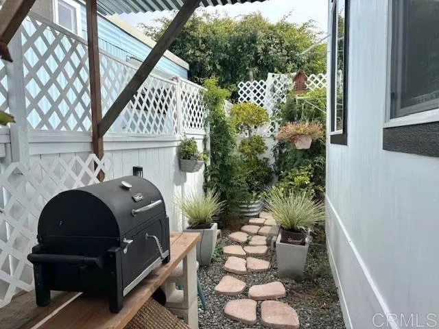 a backyard of a house with lots of green space and outdoor seating