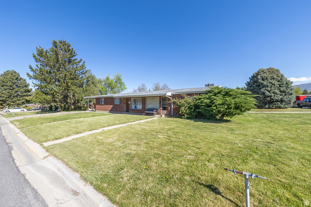 148 West Wicker Lane Bountiful, UT 84010 - Photo 2 of 27 Ranch-style home with covered porch, a front lawn, and brick siding