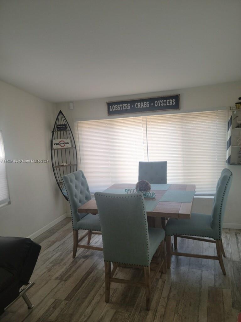 3201 Canal Drive, Unit 2 Pompano Beach, FL 33062 - Photo 3 of 12 a view of a dining room with furniture window and wooden floor