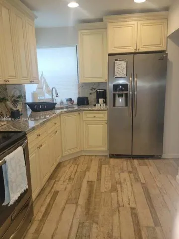 a view of a porch with chairs and potted plants