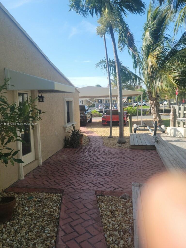 3201 Canal Drive, Unit 2 Pompano Beach, FL 33062 - Photo 9 of 12 a view of a patio with a table and chairs