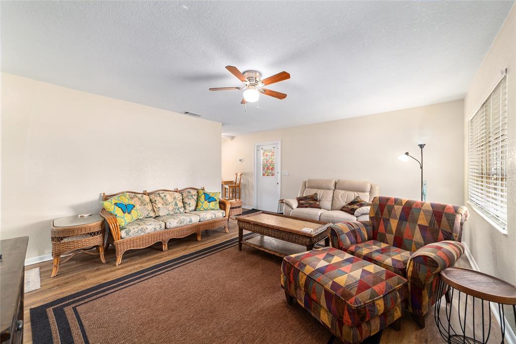 21529 Southwest Honeysuckle Street Dunnellon, FL 34431 - Photo 11 of 55 a living room with furniture a table and a chandelier